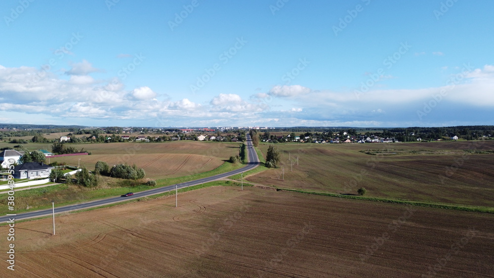 Fototapeta premium Top view of an asphalt road in the fields