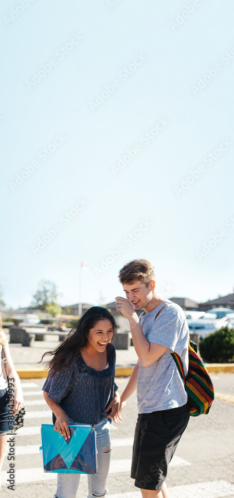 High school aged teens laughing together outside High school aged teens laughing together outside