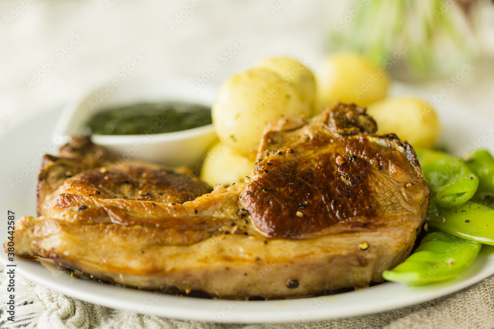 Meat and two veg dinner of lamb chops with mangetout and new potatoes