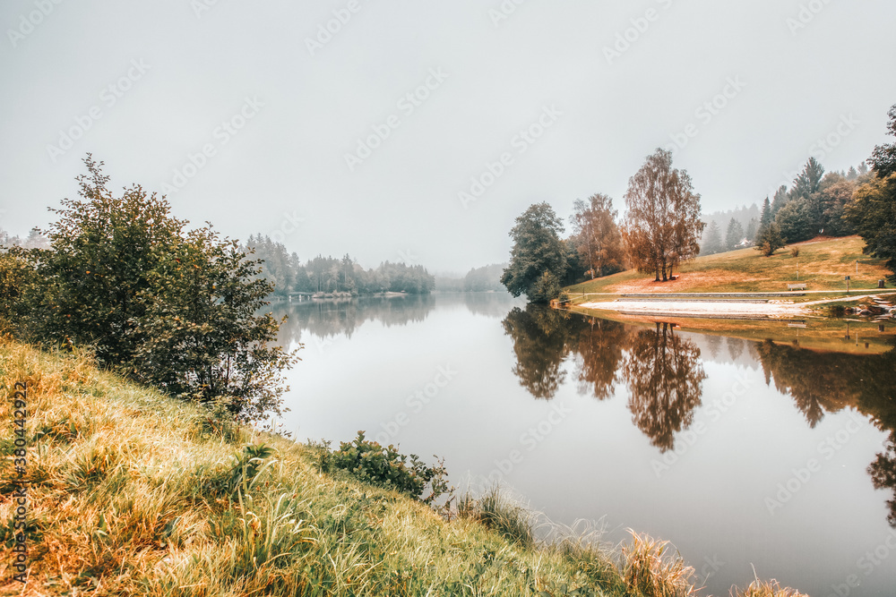 beautiful morning fog on a lake in bavaria