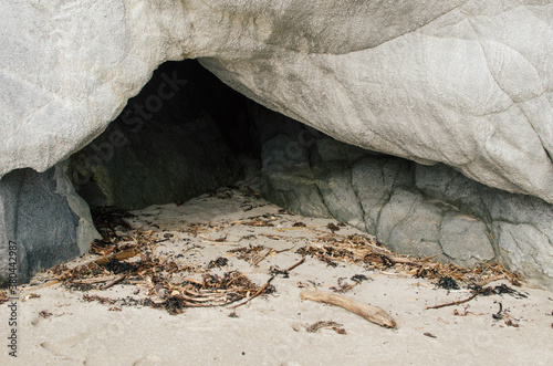 Sea cave along beach photo