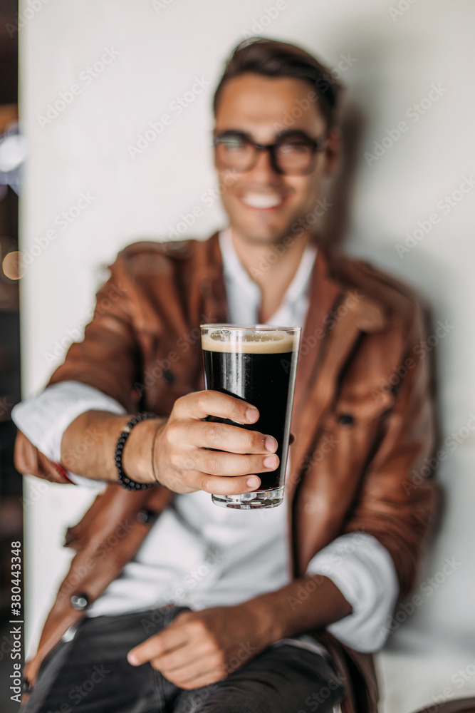 Man holding beer in a bar. Man holding beer in a bar.