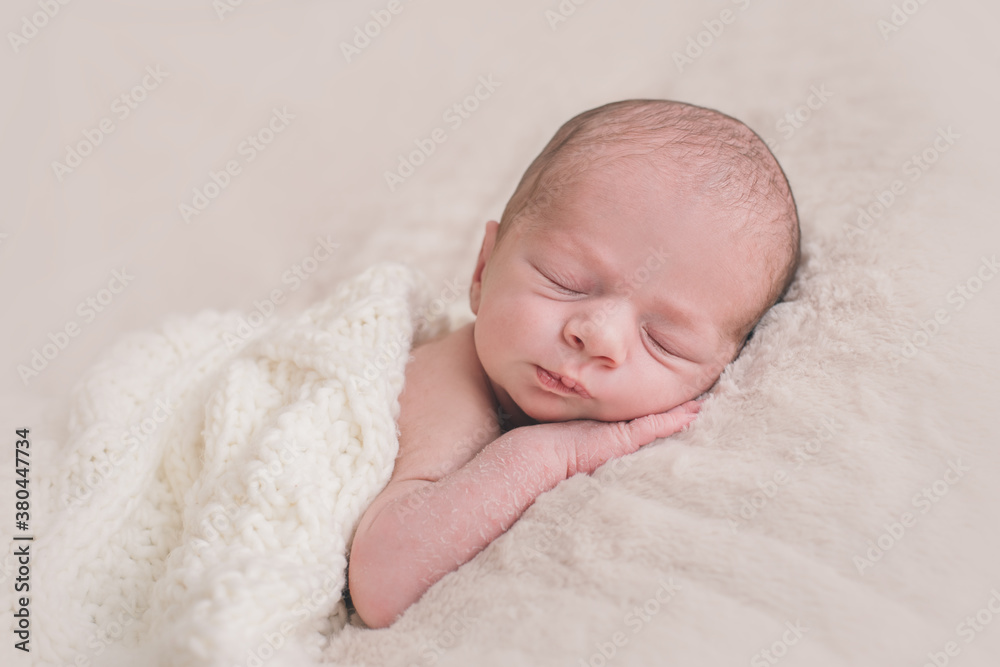 Portrait of a sleeping newborn baby with a funny frown on his face Portrait of a sleeping newborn baby with a funny frown on his face
