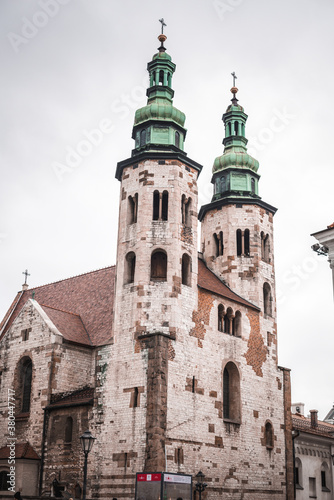 large stone church with two green domes on a background of cloudy sky © Nazar
