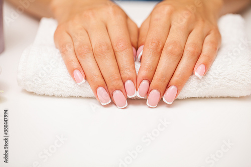 The picture of female hands with perfectly done manicure.