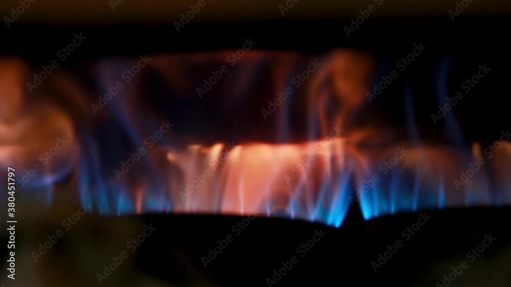 Flame that is heating a coffee roaster, and with blue an orange flames Flame that is heating a coffee roaster, and with blue an orange flames