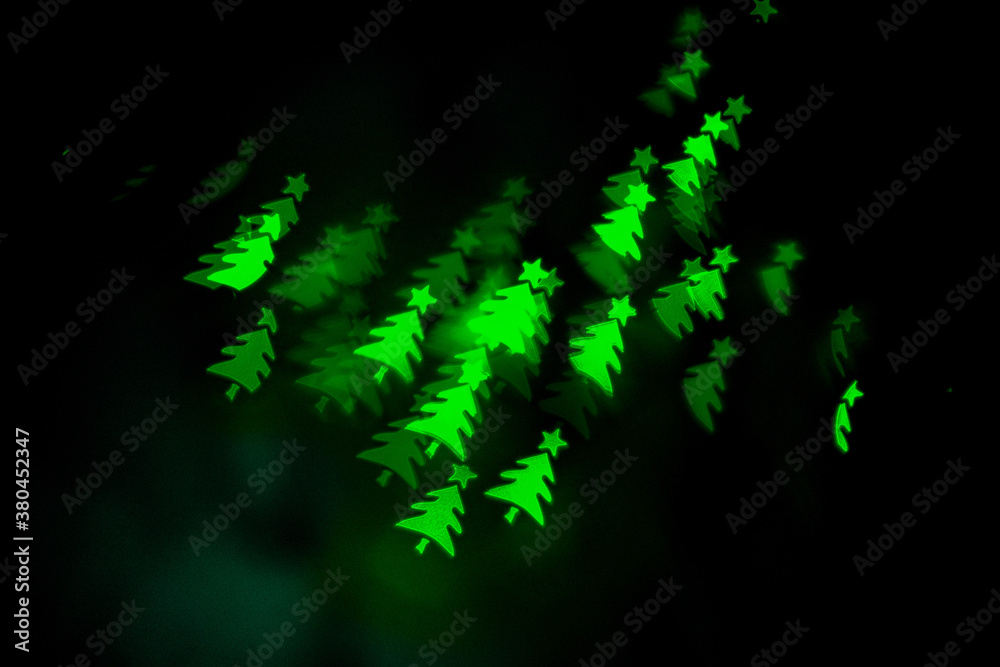 Bokeh in the shape of a Christmas tree. New year background. Selective focus