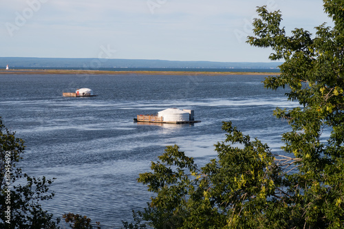 View of floating yurts in the bay of Carleton-sur-mer, Canada © jonas