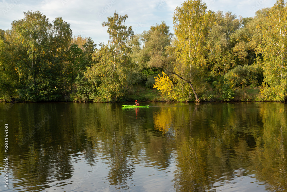 Sportsman kayaking on the river. Autumn landscape. Moscow river in Strogino, Moscow