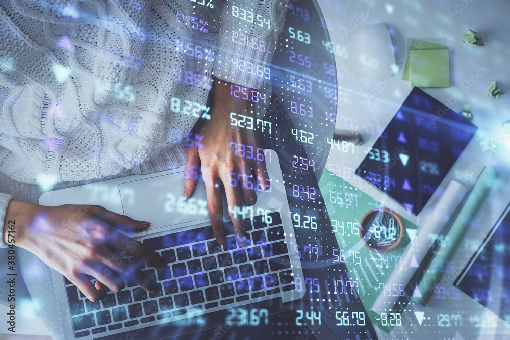 Multi exposure of woman hands working on computer and forex chart hologram drawing. Top View. Financial analysis concept. Multi exposure of woman hands working on computer and forex chart hologram drawing. Top View. Financial analysis concept.