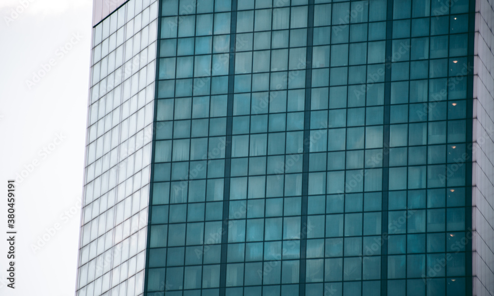 Glass windows of an office building in a modern city in the financial district Glass windows of an office building in a modern city in the financial district
