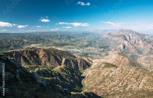 View of a mountainous landscape and rural town from a mountain top