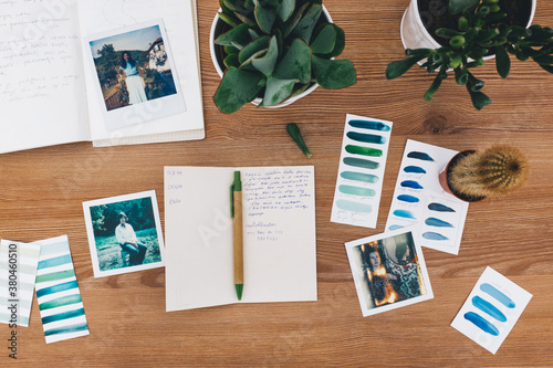 Vintage Polaroids and Notebook on a Wooden Surface