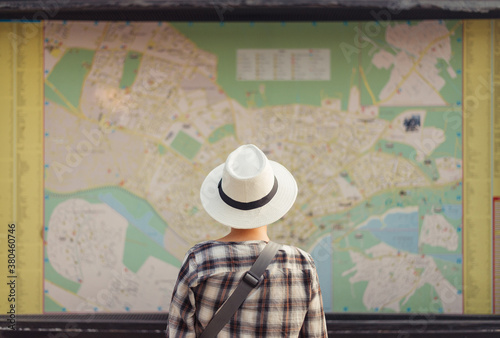 Woman standing in front of large map photo