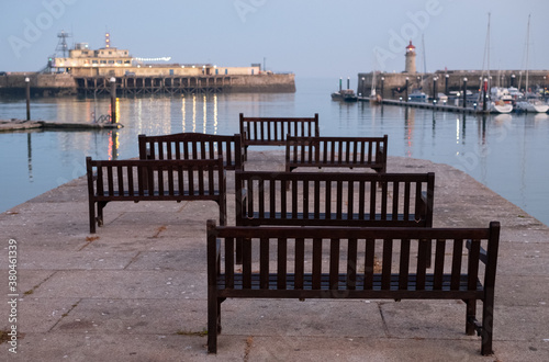 View of Ramsgate Royal Harbour, Kent UK,  taken in the early evening light with benches laid out of the jetty.  © Lois GoBe