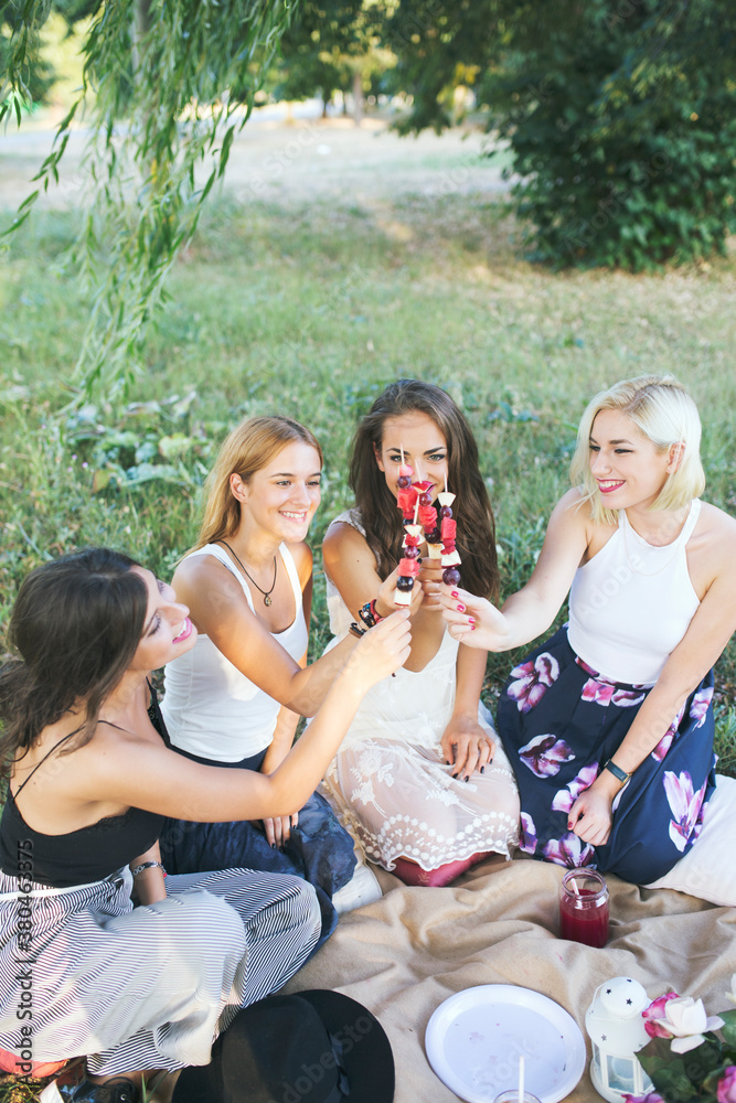 Happy female friends on a picnic in nature Happy female friends on a picnic in nature