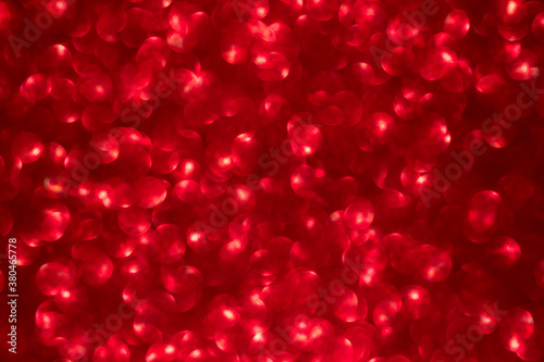 Red color bokeh lighting background. glittering blurred texture.