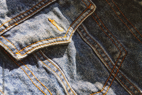 blue denim background on the sides with seams of brown threads