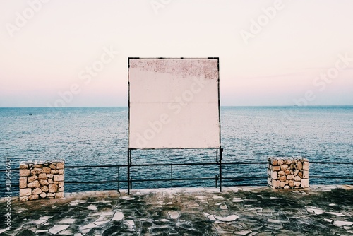 Blank Billboard by the sea at evening