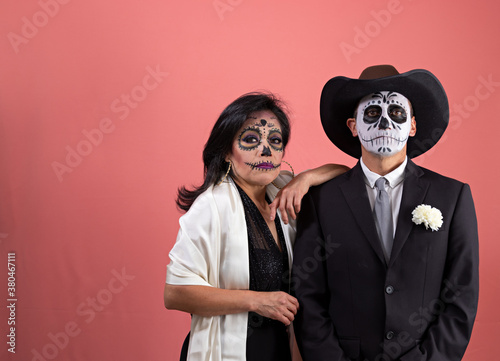 Mexican couple dressed as a catrina and catrin photo