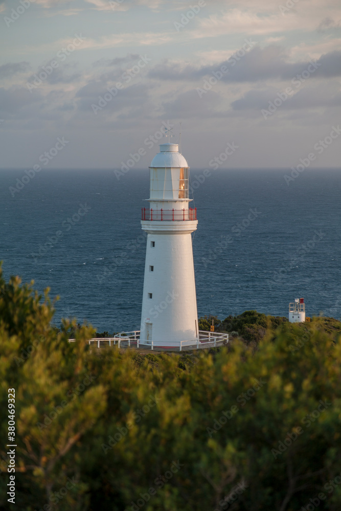 Remote lighthouse with ocean in background Remote lighthouse with ocean in background