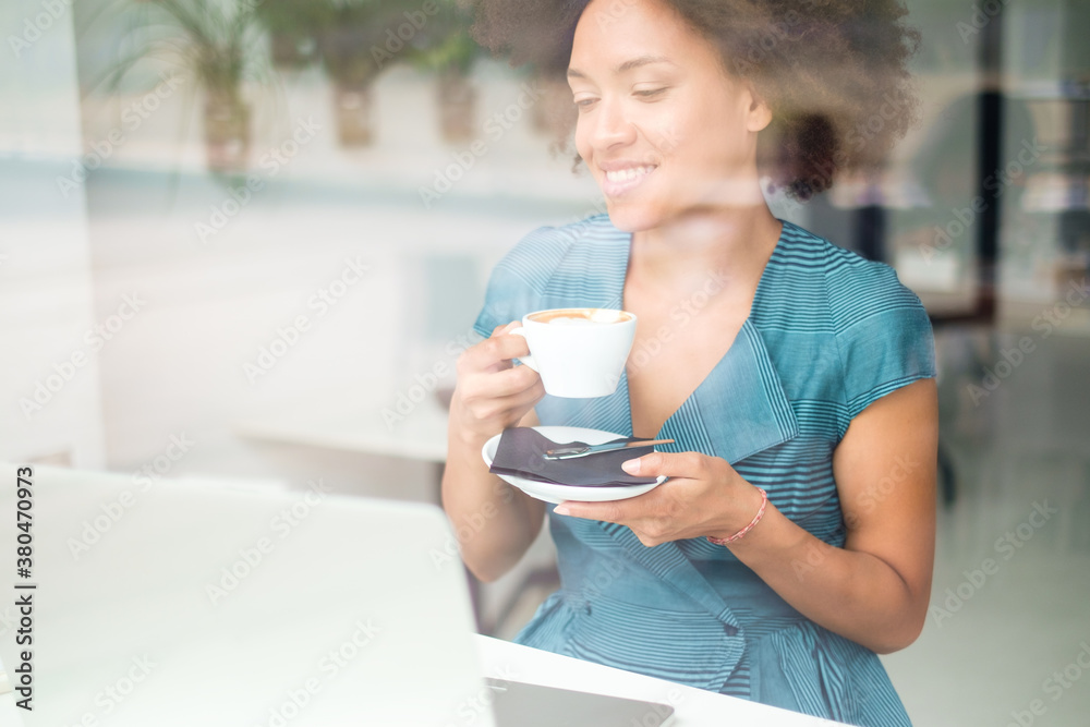 Beautiful Smiling Woman Drinking Coffee And Looking At The Computer Beautiful Smiling Woman Drinking Coffee And Looking At The Computer