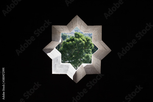 Star shaped window and tree on the outside photo