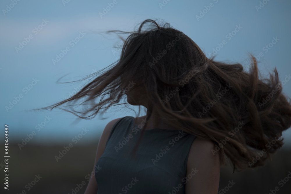 Portrait of a young woman with wind in her hair Portrait of a young woman with wind in her hair