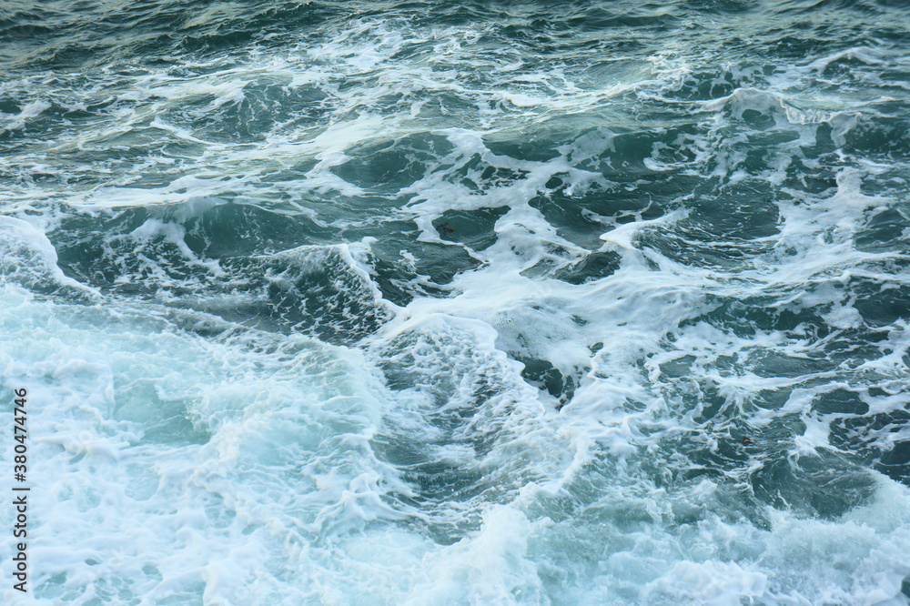 Waves and foam on the sea surface. abstraction. background.
