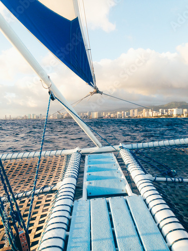 The Bow And Foremast Of A Catamaran Sailing Off The Coast Of Honolulu photo