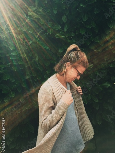 Girl Dancing in a Sweater in the Sunshine photo