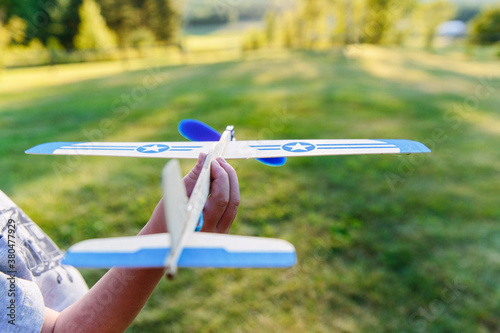 Child Playing with Balsa Wood Airplane