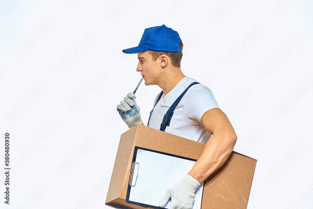 Man worker with box in hands delivery loading service work light background Man worker with box in hands delivery loading service work light background