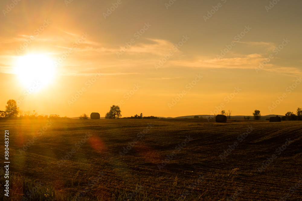Beautiful view of a field with haystacks, during golden hour Beautiful view of a field with haystacks, during golden hour