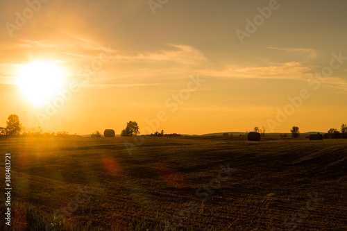 Beautiful view of a field with haystacks, during golden hour