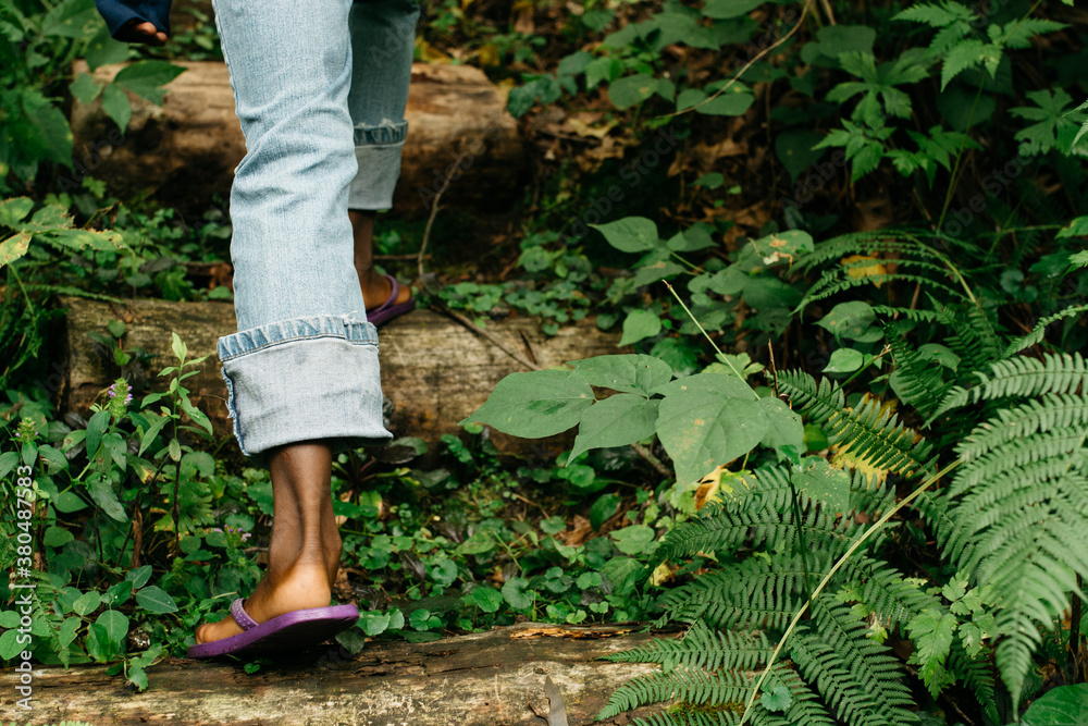 African American girl's feet in flip-flops on a nature walk African American girl's feet in flip-flops on a nature walk