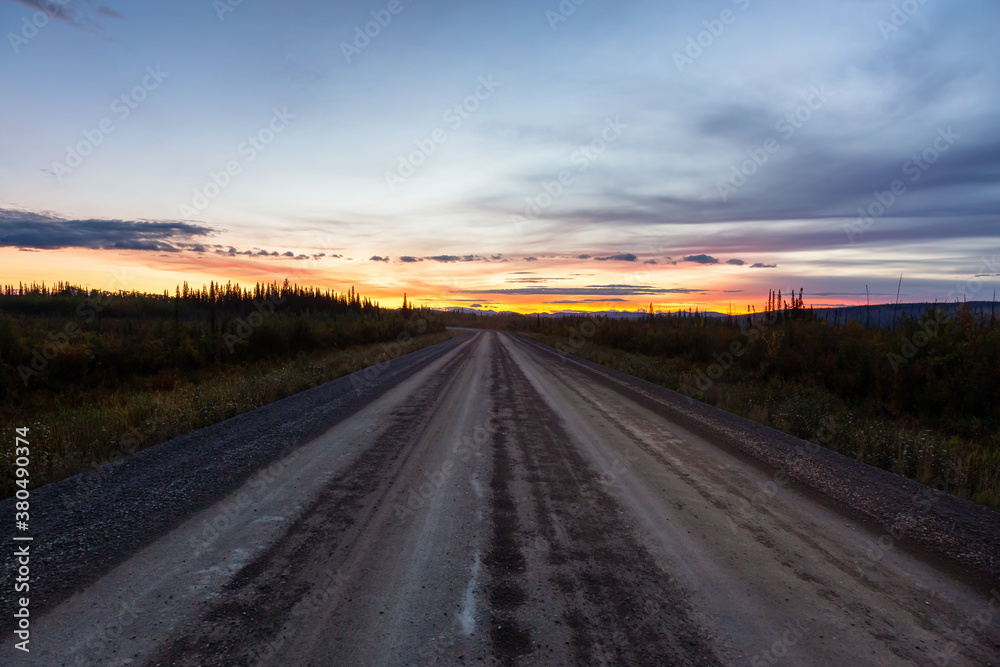View of Scenic Road leading to Tombstone at Sunrise in Canadian Nature. Dempster Highway, Yukon, Canada.