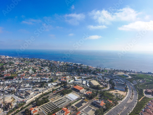 Obraz na płótnie a stunning aerial shot of the beach front community, blue sky, clouds and deep b