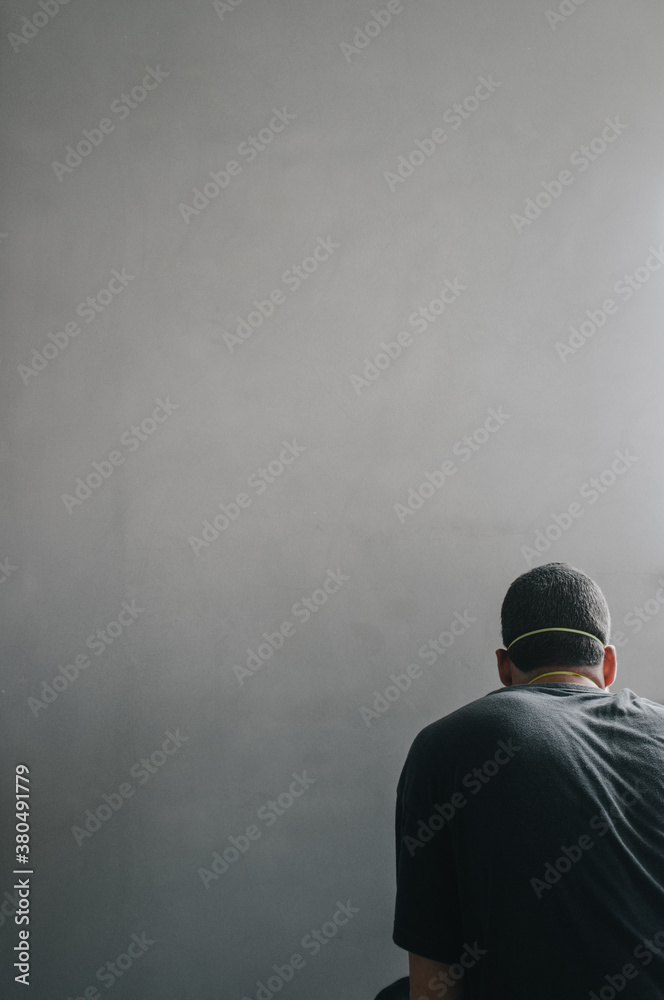 Man is sanding the wall