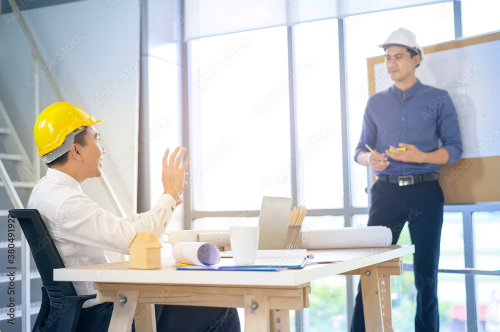young male and female engineer presenting the ideas and discuss plans to colleague in a meeting room, Group people business concept young male and female engineer presenting the ideas and discuss plans to colleague in a meeting room, Group people business concept