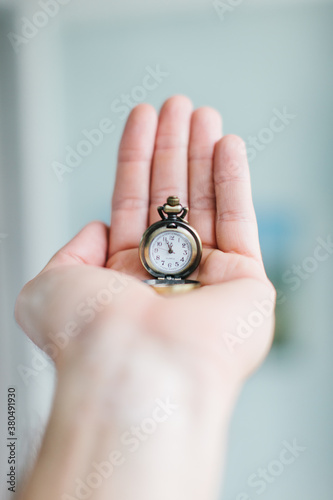 Hand holding mini pocket watch