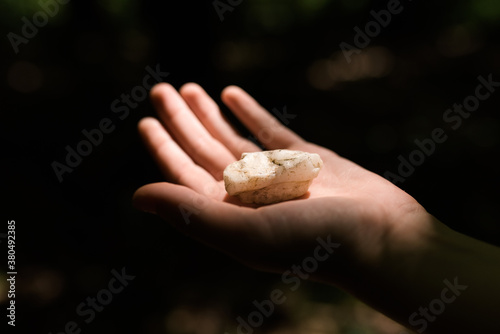 piece of marble in a hand lit by the sun photo