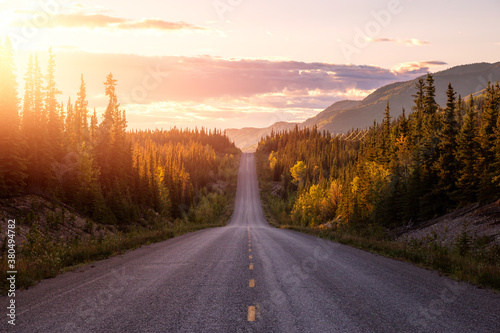 Scenic Road View of Klondike Hwy during a sunny and colorful sunset. Taken North of Whitehorse, Yukon, Canada. photo