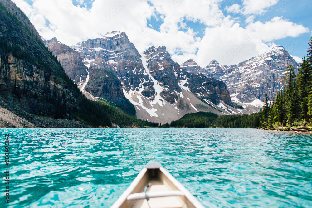 First person view canoeing through clear blue water First person view canoeing through clear blue water