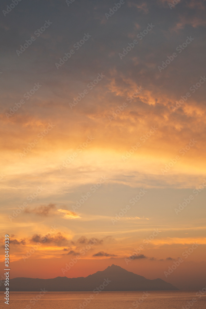 Minimalist seascape at dawn with nice clouds above Athos, Greece Minimalist seascape at dawn with nice clouds above Athos, Greece