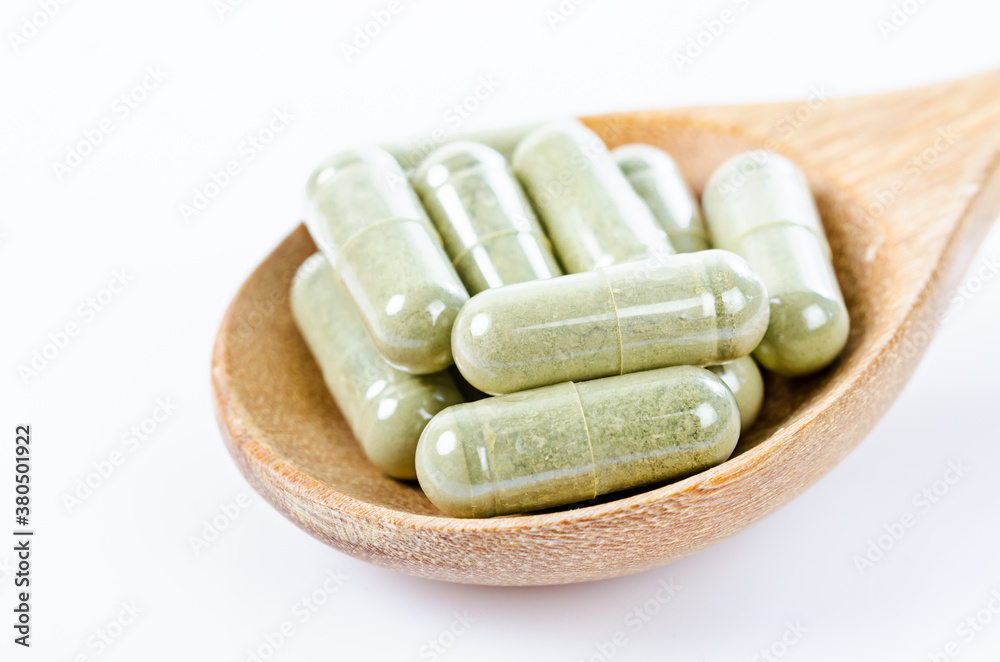 Herbal capsules from herbs in wooden spoon for healthy. Herbal capsules from herbs in wooden spoon for healthy.