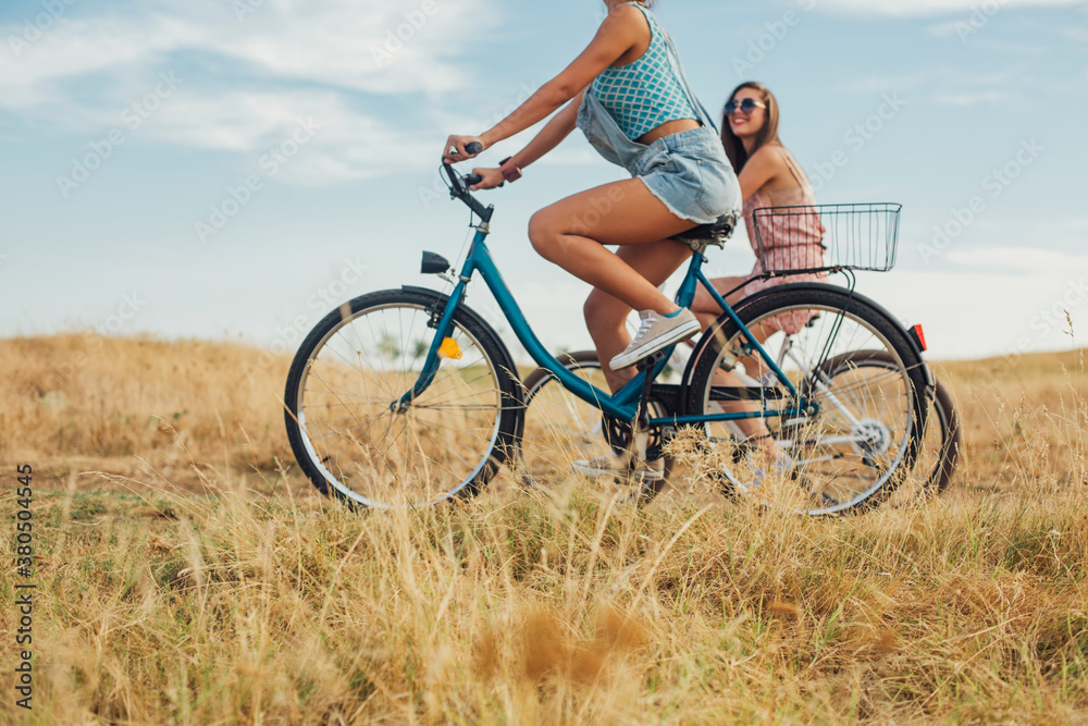 Two Girls Riding Bicycles Together Two Girls Riding Bicycles Together