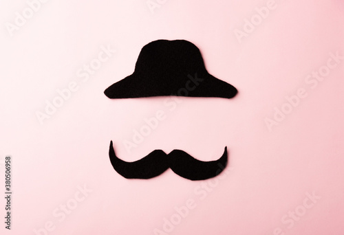 Black mustache and cap, studio shot isolated on pink background, Prostate cancer awareness month, Fathers day, minimal November moustache concept