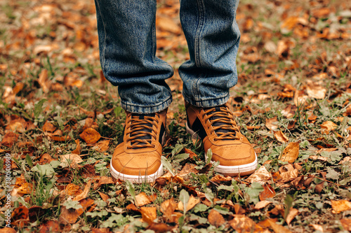 Sneakers man on autumn leaves banner copy space leisure autumn men's shoes leisure