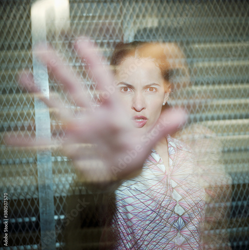 Angry young woman reaching towards camera